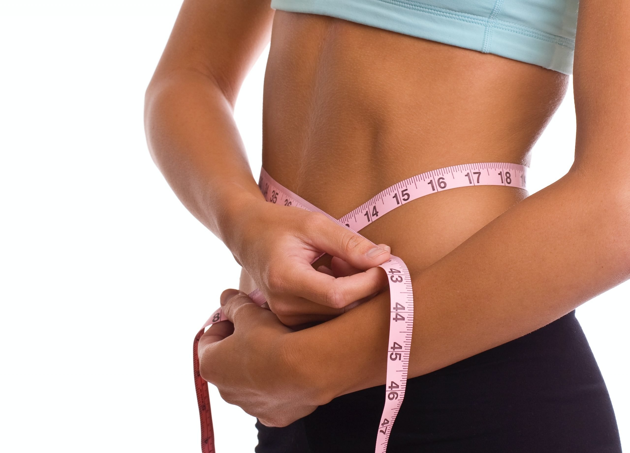 Woman measuring stomach with measuring tape